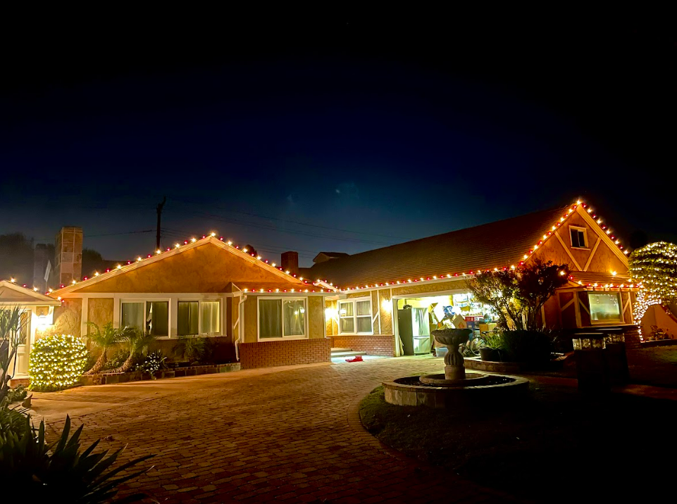 christmas light installation in los alamitos with lights running across the roof trim